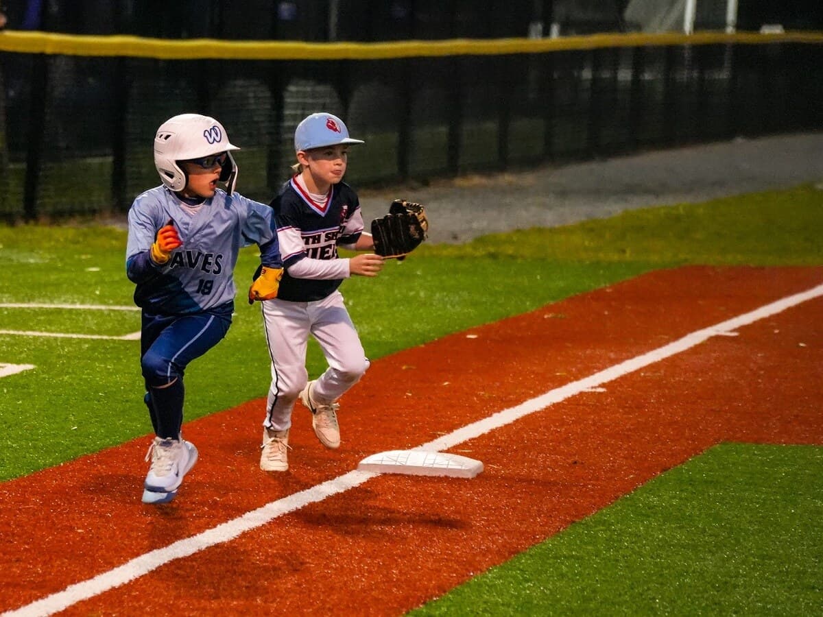 Waves player competing through first base with another player in the play